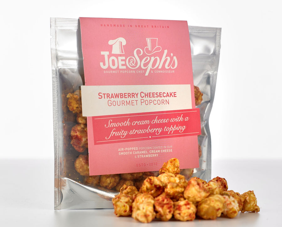 Joe & Seph's gourmet popcorn in Strawberry Cheesecake flavour. This has been set on a white table top.